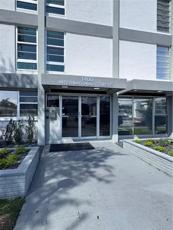 a front view of a building with a garden
