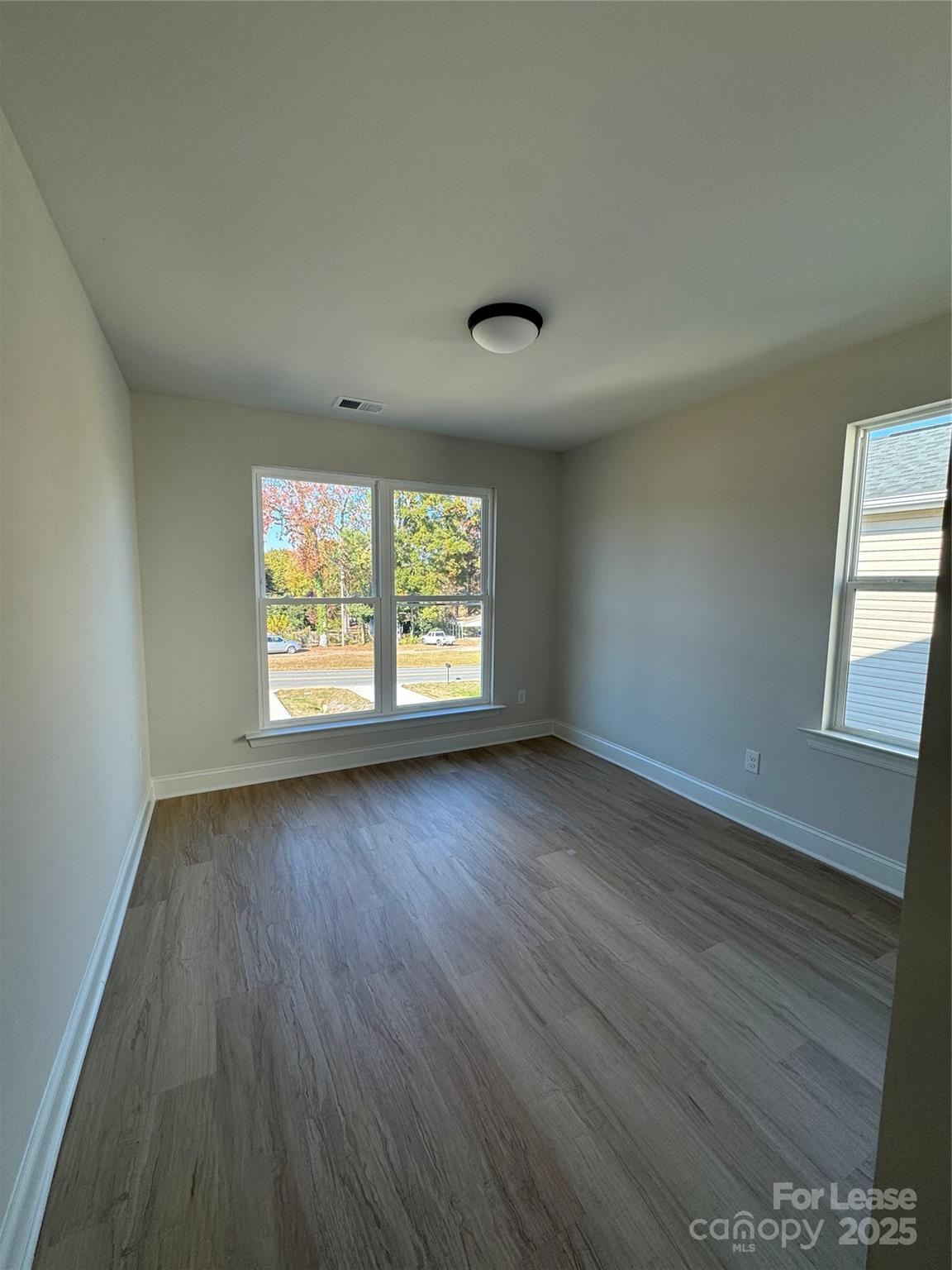 2157 Tom Sadler Road Charlotte, NC 28214 - Photo 11 of 13 an empty room with wooden floor and windows
