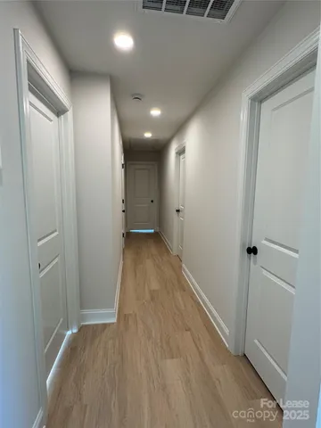 a view of hallway with wooden floor