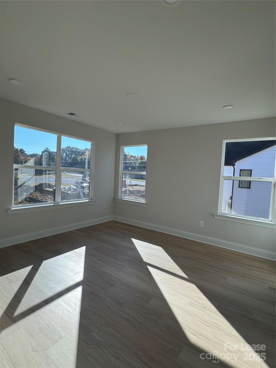 2157 Tom Sadler Road Charlotte, NC 28214 - Photo 6 of 13 an empty room with wooden floor and windows