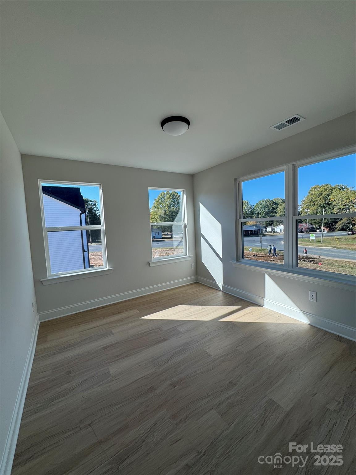 2157 Tom Sadler Road Charlotte, NC 28214 - Photo 9 of 13 a view of an empty room with a window and wooden floor