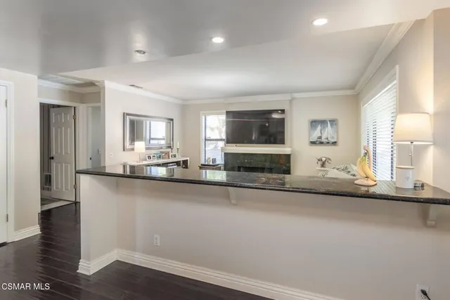 a large kitchen with granite countertop a sink and a stove top oven
