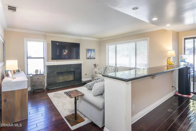 a living room with granite countertop furniture a fireplace and a window