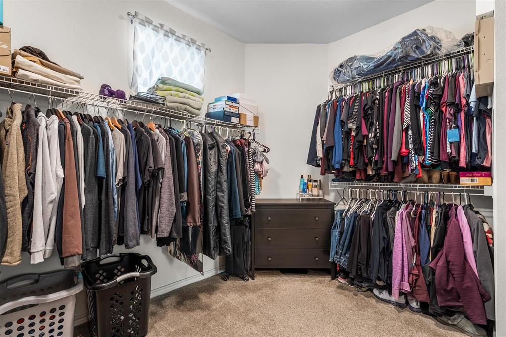 5019 Morris Avenue, Unit 22 Addison, TX 75001 - Photo 26 of 31 a view of walk in closet with clothes