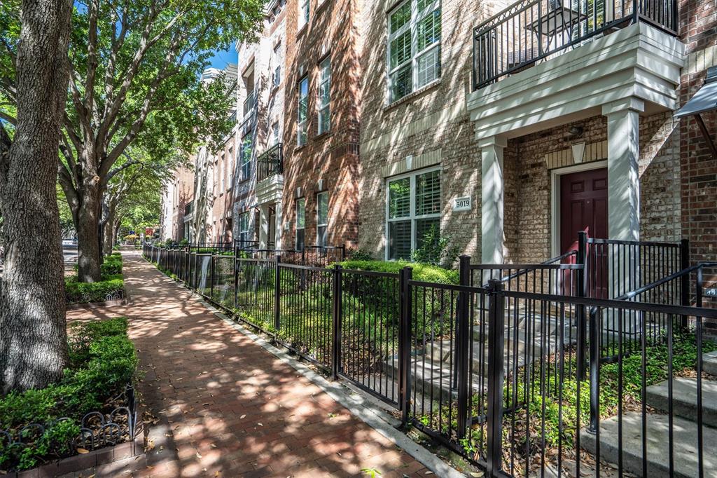 5019 Morris Avenue, Unit 22 Addison, TX 75001 - Photo 4 of 31 a view of a house with a small yard and a large tree