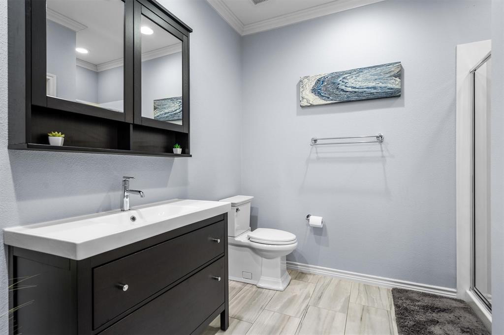 5019 Morris Avenue, Unit 22 Addison, TX 75001 - Photo 7 of 31 a bathroom with a toilet sink and mirror