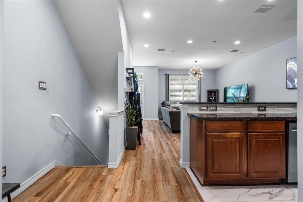 5019 Morris Avenue, Unit 22 Addison, TX 75001 - Photo 31 of 31 a kitchen with stainless steel appliances granite countertop a refrigerator a sink dishwasher a stove with wooden floor