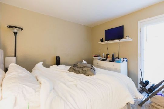925 West St George Avenue Ridgecrest, CA 93555 - Photo 19 of 24 a bedroom with a bed and a flat screen tv