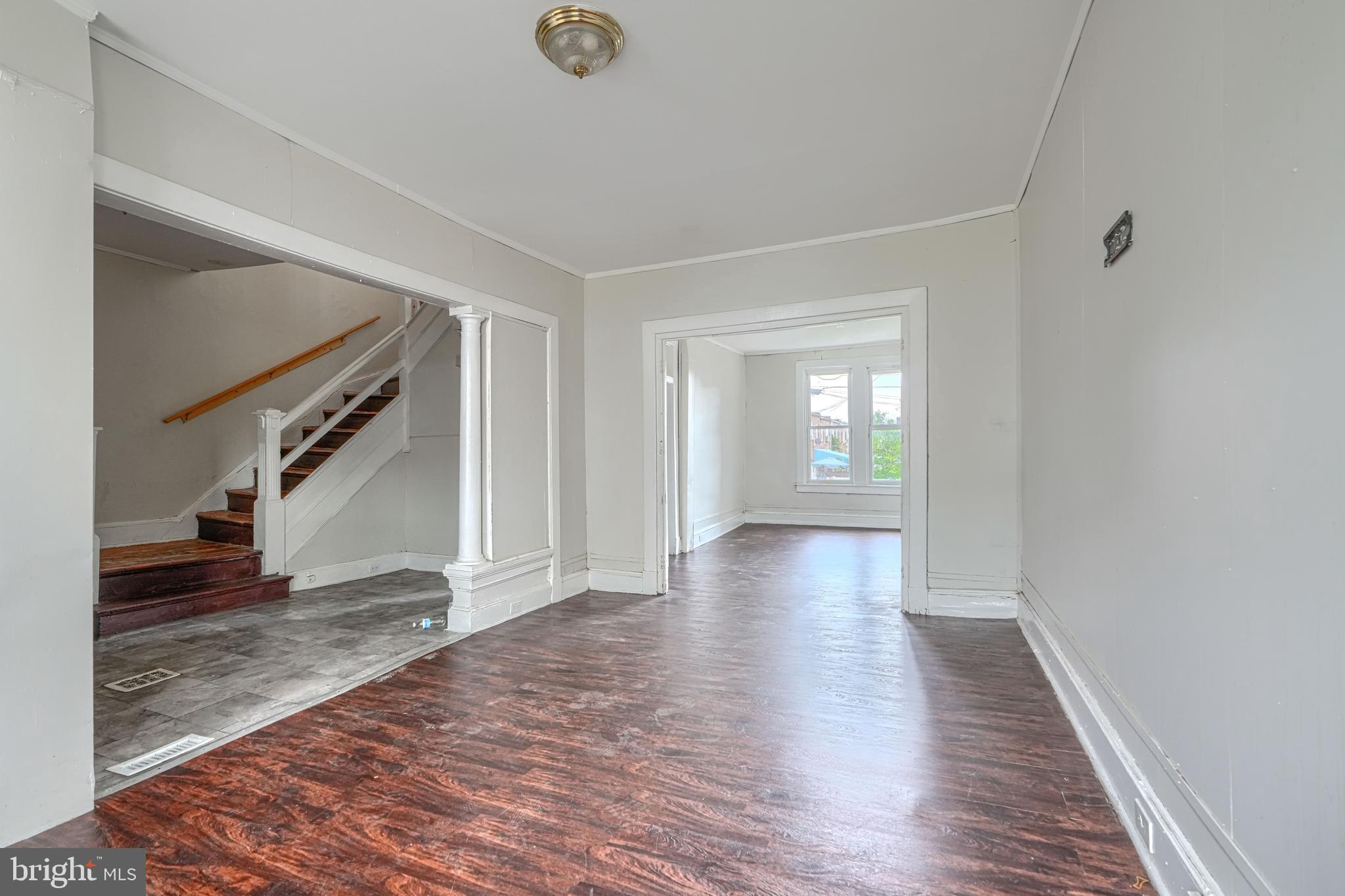 4806 Reisterstown Road Baltimore, MD 21215 - Photo 7 of 34 a view of an empty room with wooden floor and a window