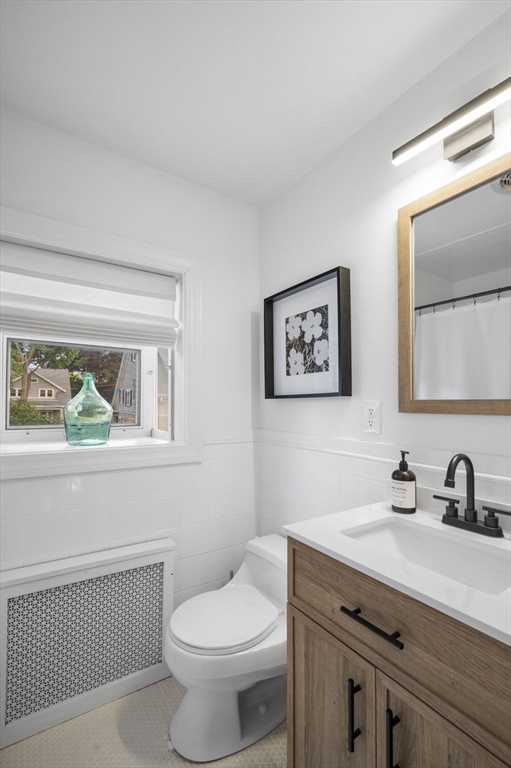 5 Chesterlee Lane Swampscott, MA 01907 - Photo 30 of 42 a bathroom with a toilet a sink and mirror