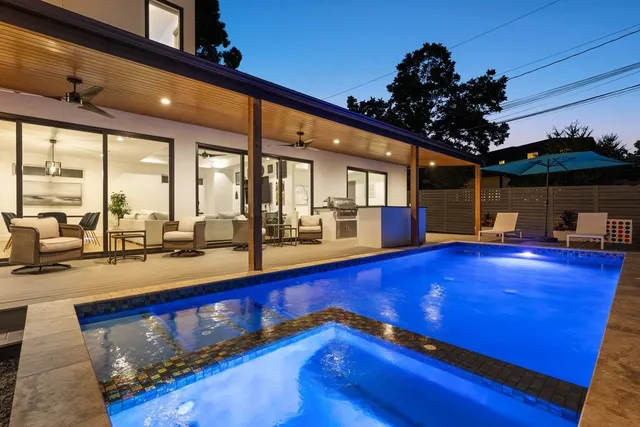 a view of a living room with furniture and kitchen view