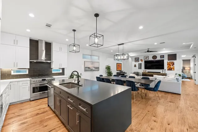 a kitchen with sink stove and cabinets