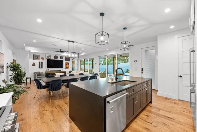 a kitchen with sink stove and living room