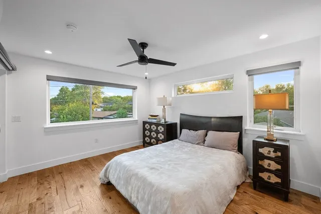 a bedroom with a large bed and a window