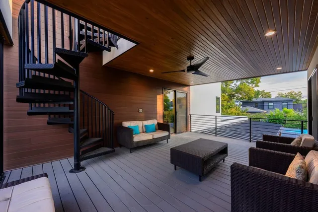 a balcony with furniture and wooden floor