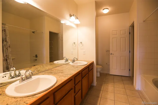 a bathroom with a sink double vanity and a mirror