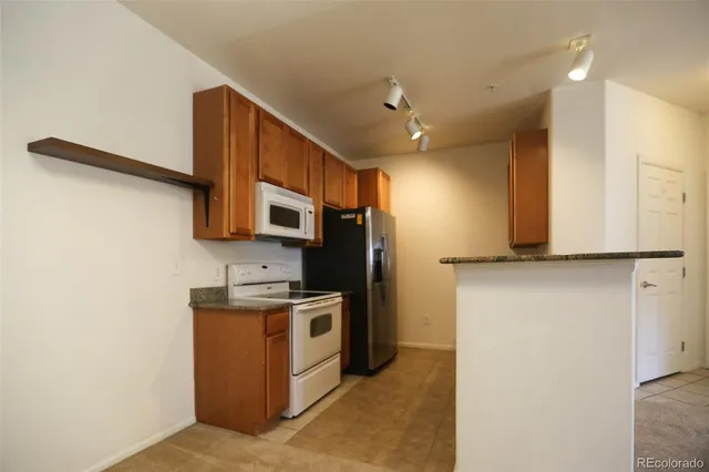 a kitchen with stainless steel appliances a refrigerator and a stove