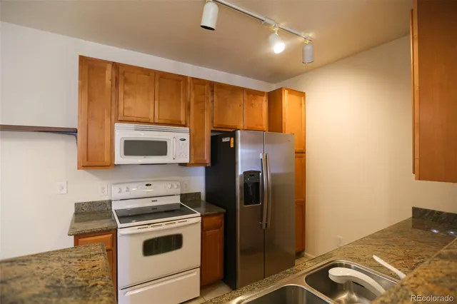 a kitchen with a refrigerator stove and microwave
