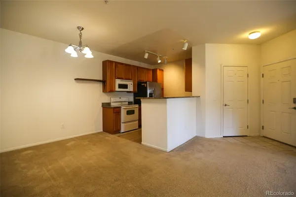a view of a kitchen with microwave and refrigerator