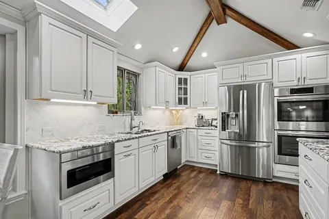 a kitchen with a sink stainless steel appliances and cabinets