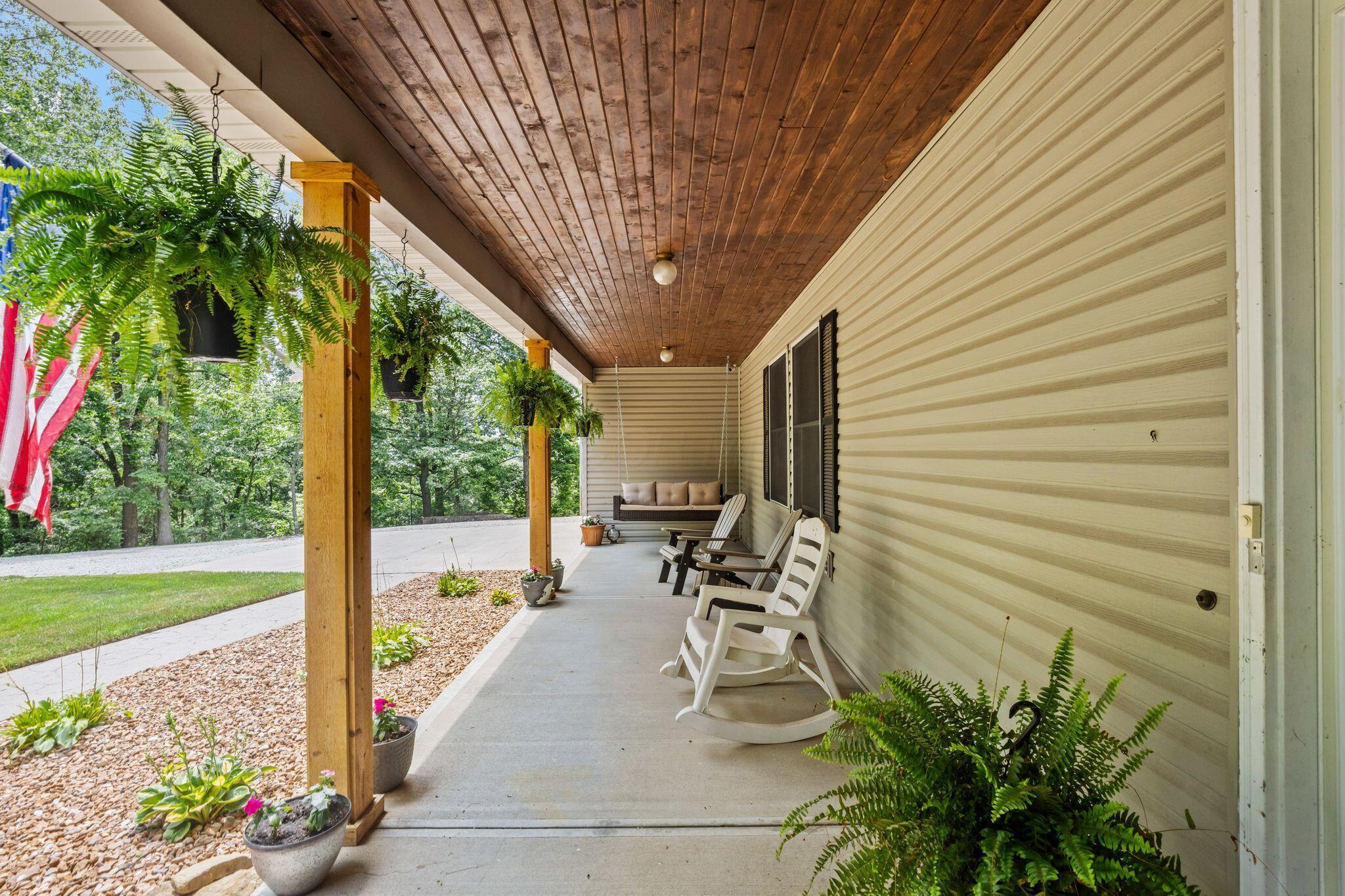 10446 Rich Hollow Road Southwest Lancaster, OH 43130 - Photo 66 of 83 Spacious covered porch featuring a wood-finish plank ceiling, light-toned siding, and sturdy wooden support columns