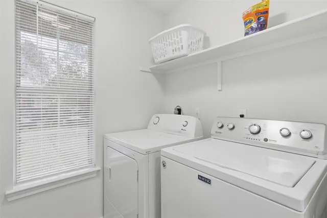 a view of washer and dryer with kitchen in the background