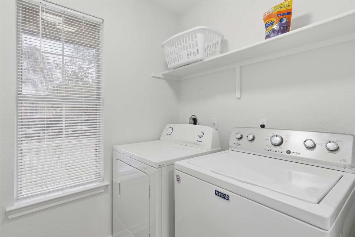 a view of washer and dryer with kitchen in the background