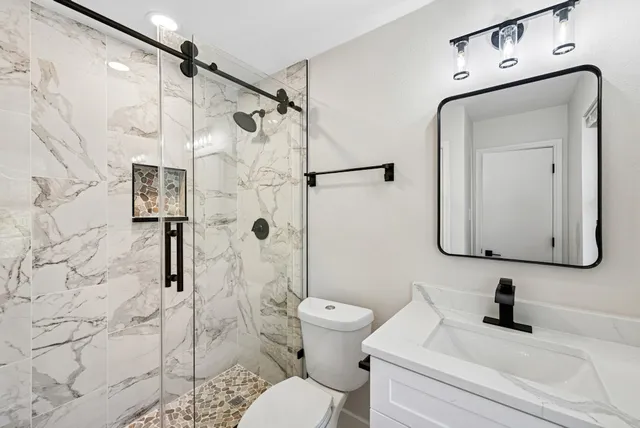 a bathroom with a sink mirror and window