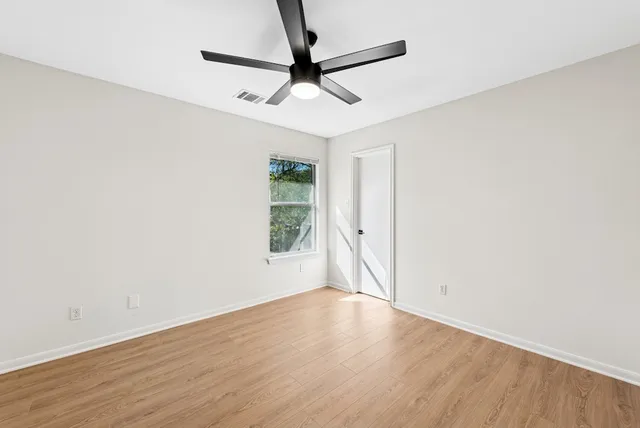 a bathroom with a toilet sink vanity and shower