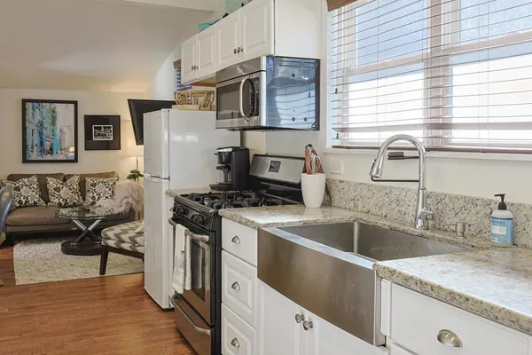 a kitchen with stainless steel appliances granite countertop a sink stove and refrigerator