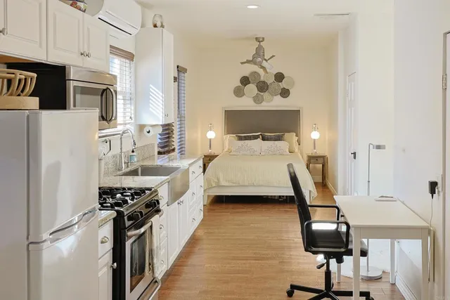 a view of a bedroom with a bed and furniture