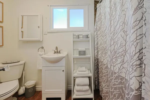 a bathroom with a sink toilet and mirror