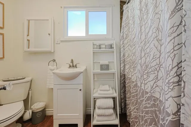 a bathroom with a sink toilet and mirror