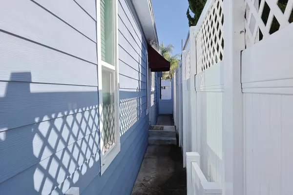 a view of staircase with lots of frames on wall and a window
