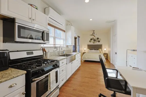a kitchen with stainless steel appliances a stove a sink and cabinets