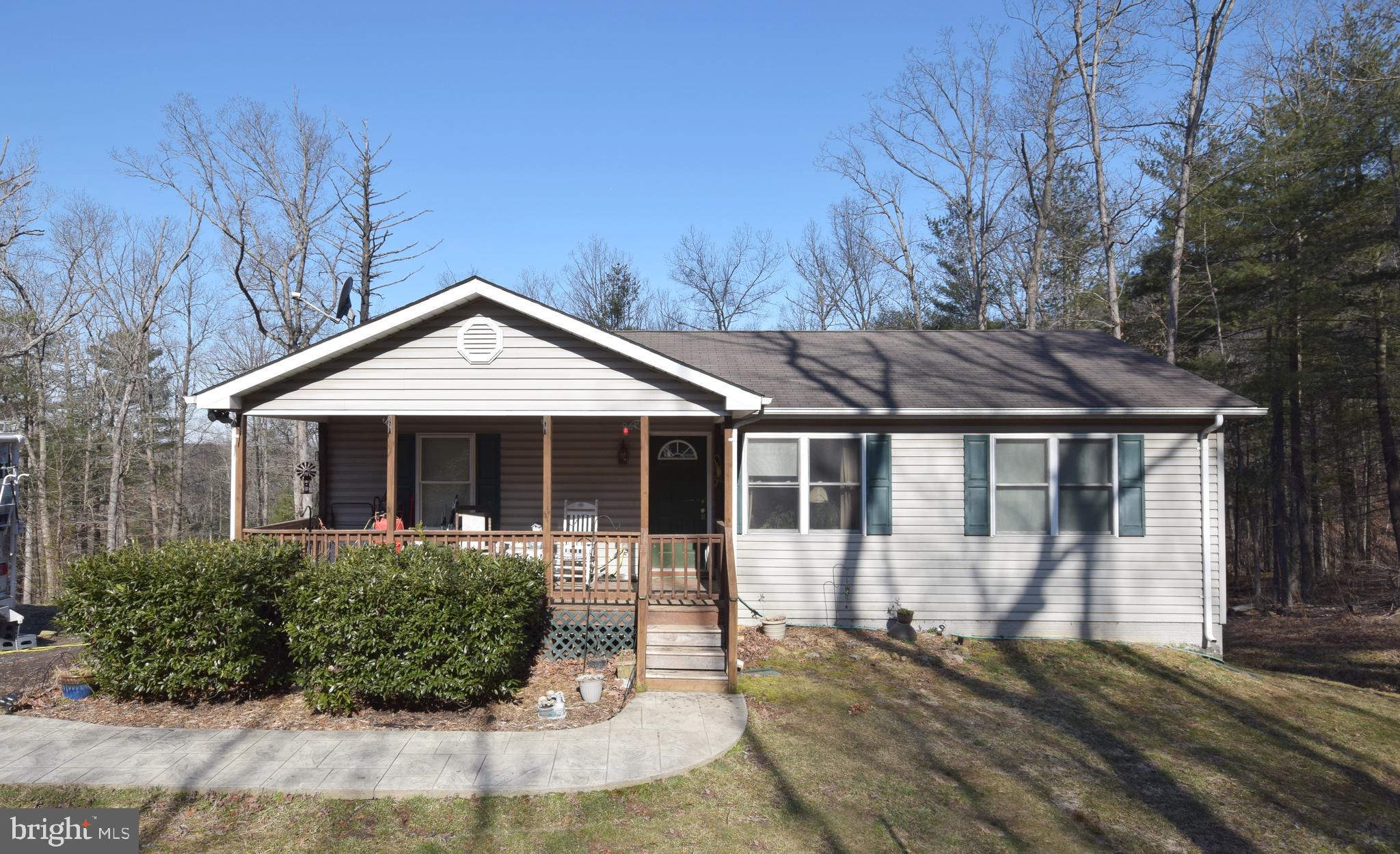 97 Spring Hollow Road Front Royal, VA 22630 - Photo 1 of 38 a front view of a house with garden