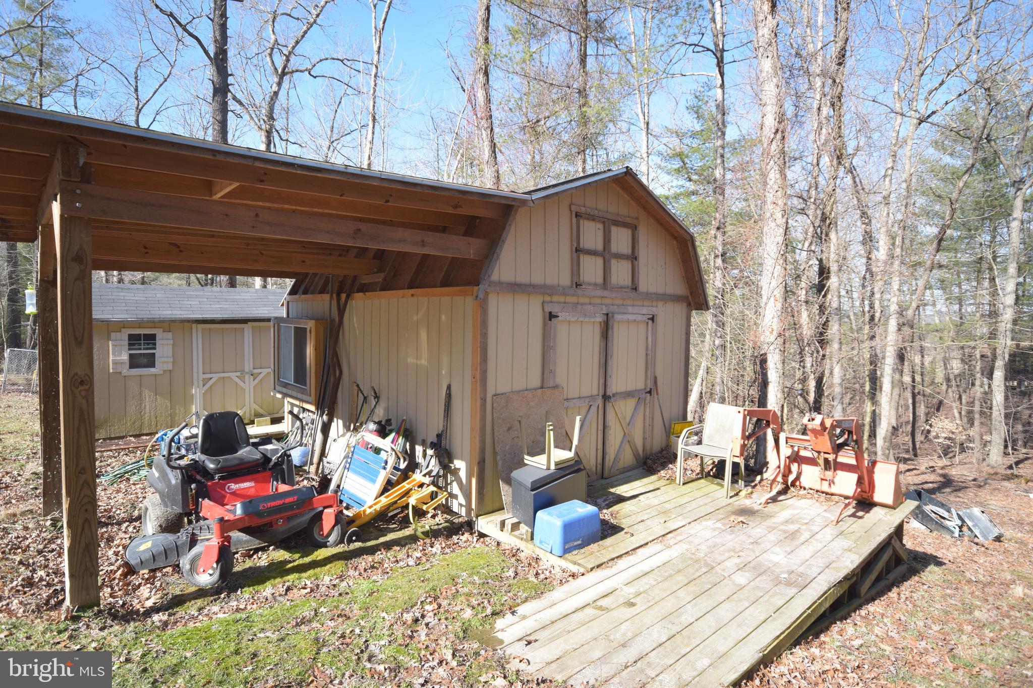 97 Spring Hollow Road Front Royal, VA 22630 - Photo 12 of 38 a view of a storage house with wooden floor and furniture