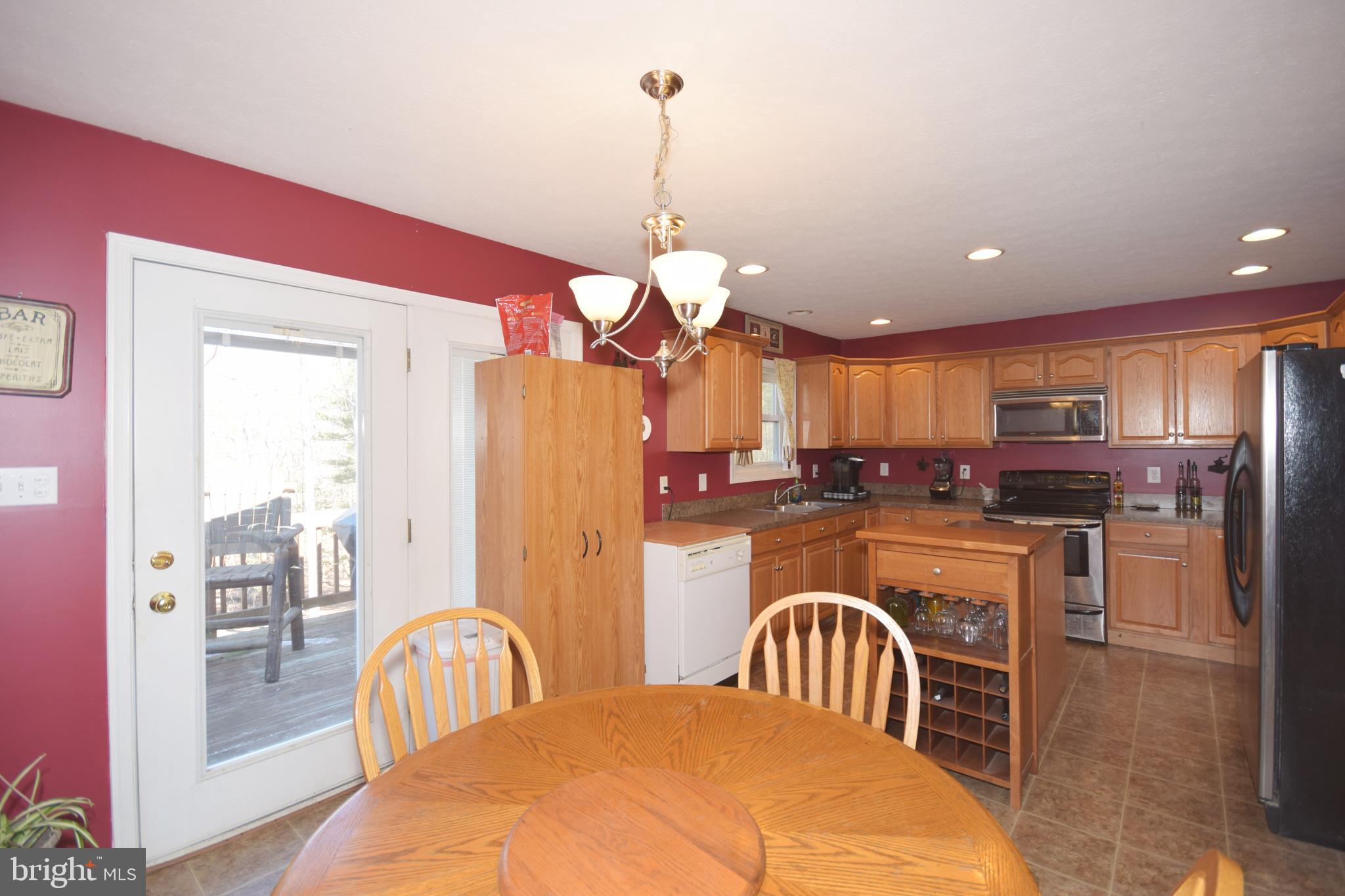 97 Spring Hollow Road Front Royal, VA 22630 - Photo 16 of 38 a dining room filled a chandelier a glass table and chairs