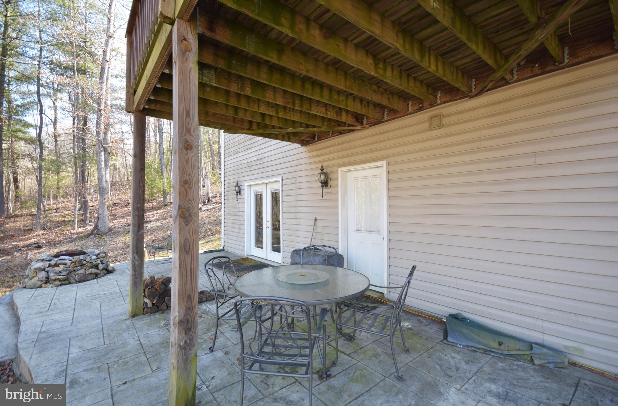 97 Spring Hollow Road Front Royal, VA 22630 - Photo 6 of 38 a patio with a table and chairs and potted plants