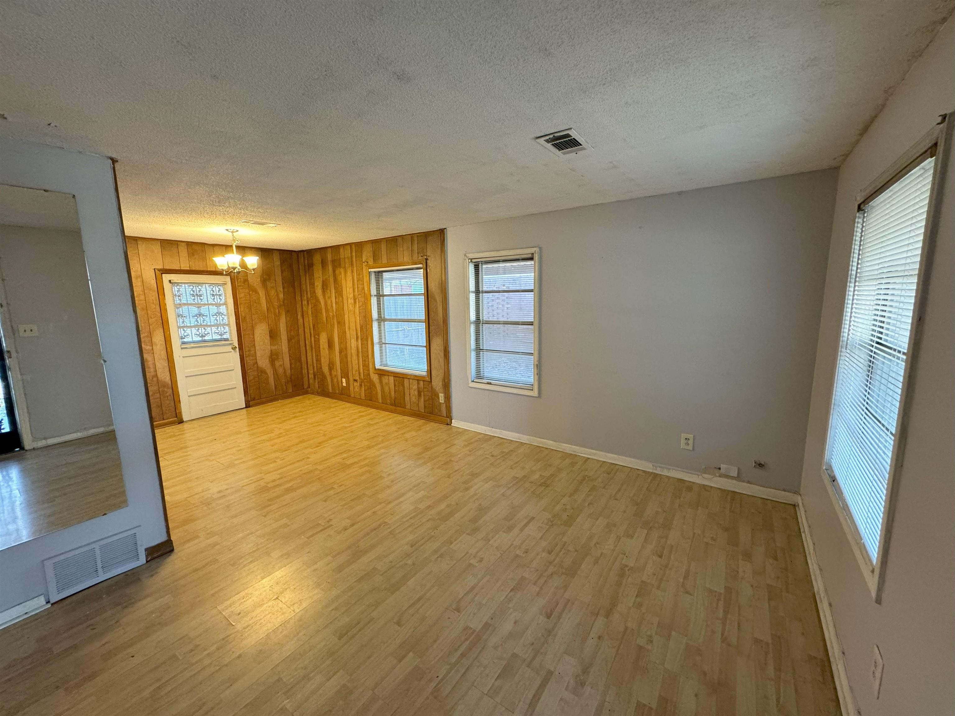 4783 Owen Road Memphis, TN 38122 - Photo 3 of 16 a view of an empty room with wooden floor and a window