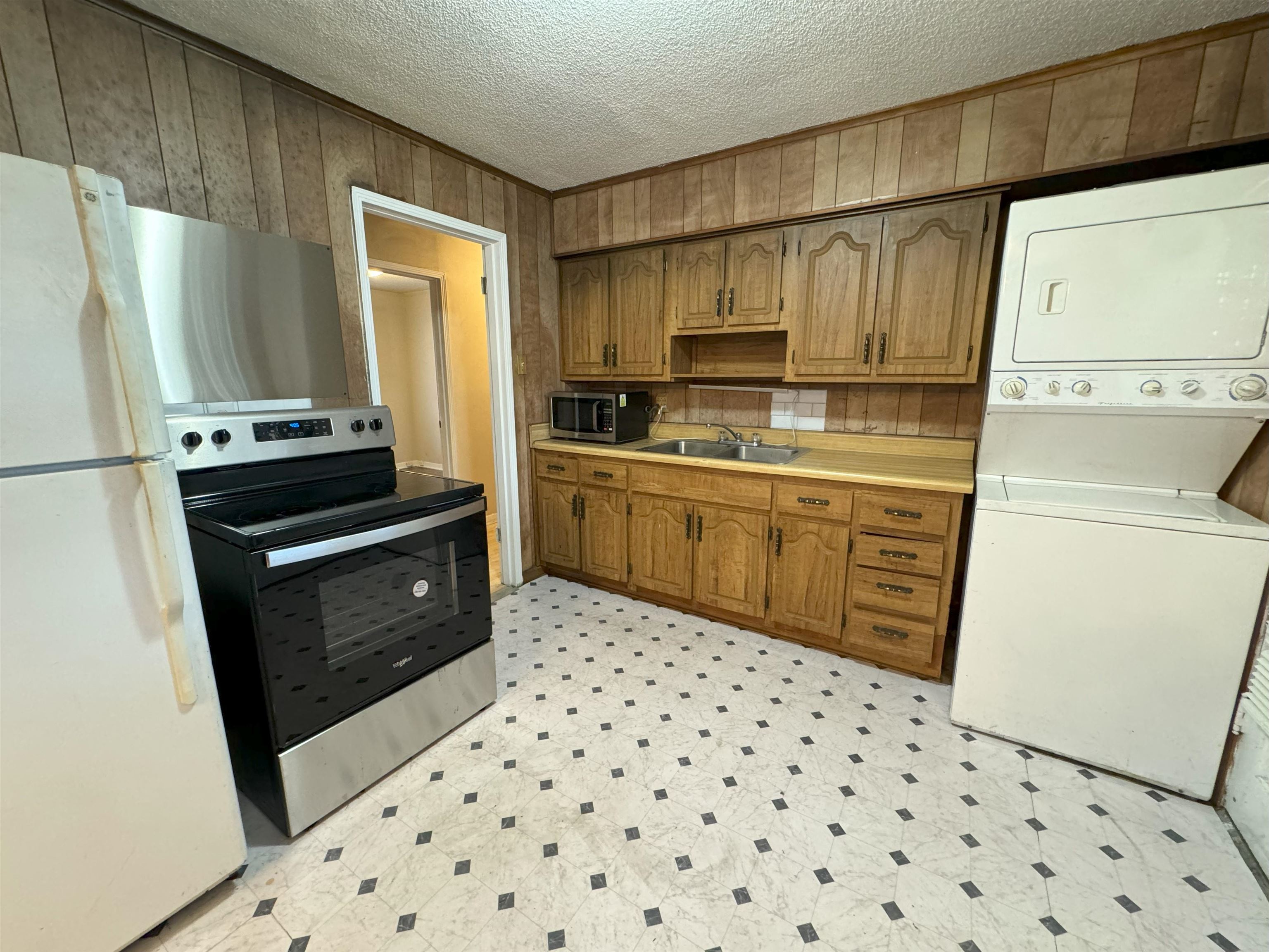 4783 Owen Road Memphis, TN 38122 - Photo 8 of 16 a kitchen with granite countertop a refrigerator stove and sink