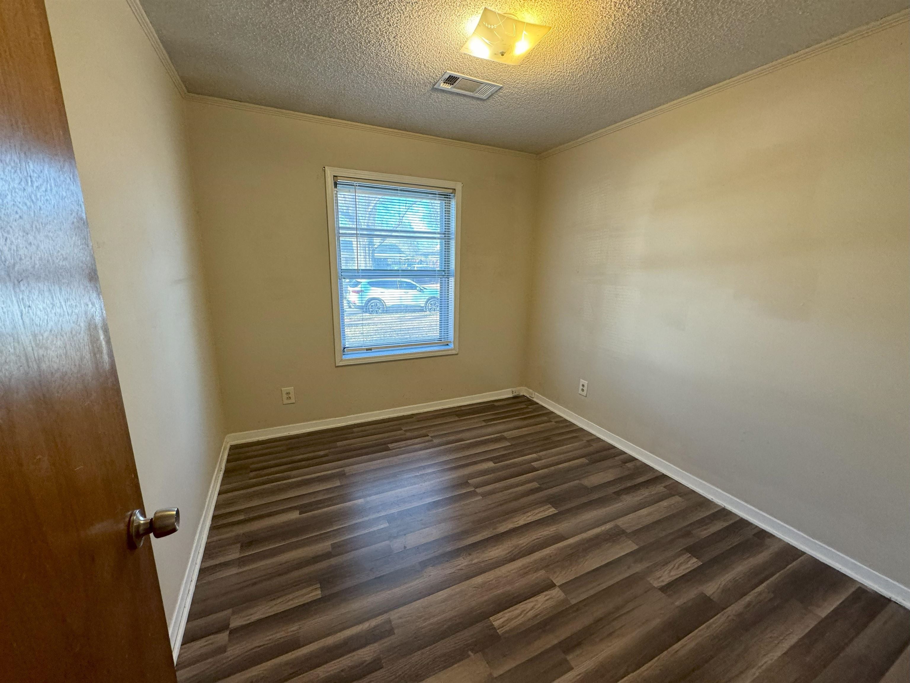 4783 Owen Road Memphis, TN 38122 - Photo 9 of 16 a view of an empty room with wooden floor and a window