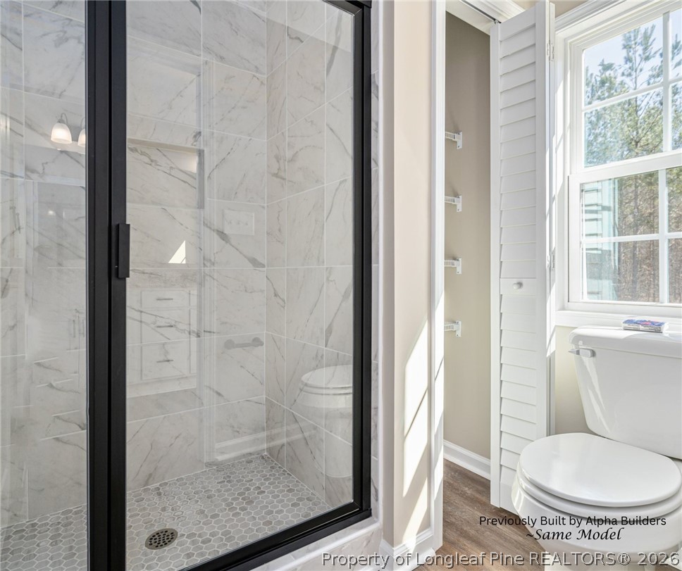 973 Martin Road St. Pauls, NC 28384 - Photo 9 of 19 Elegant tiled walk-in shower in the primary suite bath.