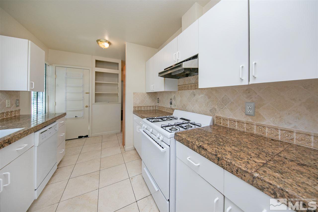 1130 West 1st Street Reno, NV 89503 - Photo 3 of 32 a kitchen with a stove and a sink
