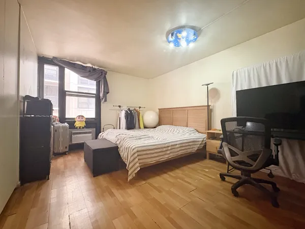 a bedroom with a bed and a large mirror