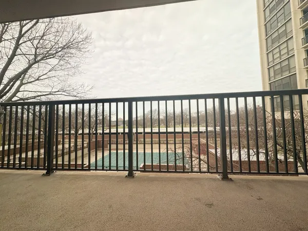 a spacious bedroom with a bed and wooden floor