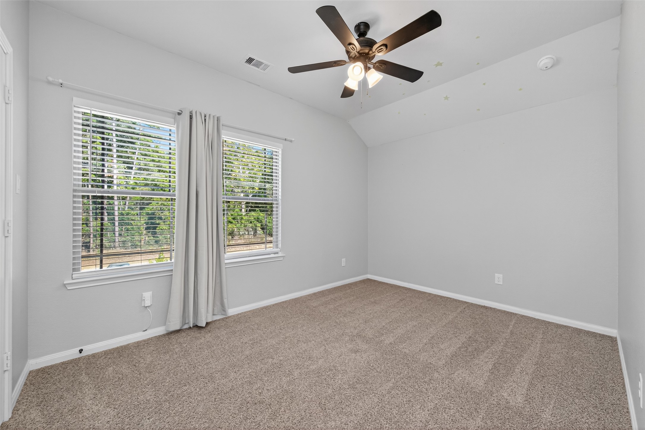 26108 Morgan Cemetery Road Cleveland, TX 77328 - Photo 18 of 39 an empty room with a window and a fan