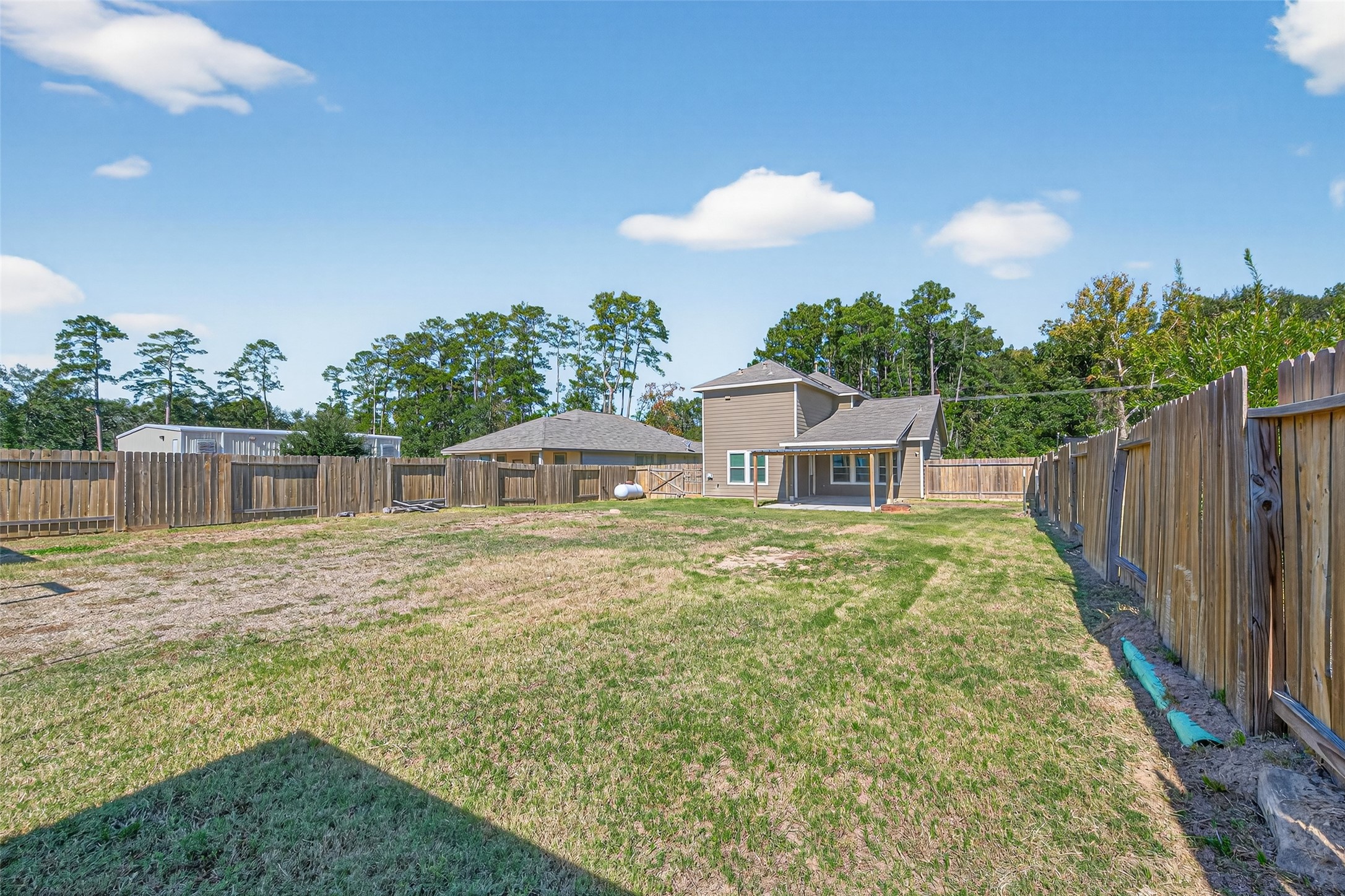 26108 Morgan Cemetery Road Cleveland, TX 77328 - Photo 34 of 39 a view of a house with a yard and potted plants