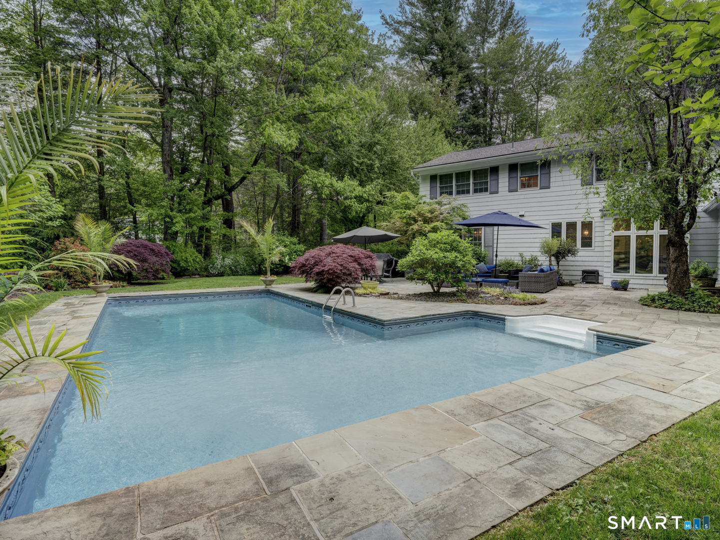 78 Windtree Street Torrington, CT 06790 - Photo 9 of 40 a front view of a house with a yard and a garden