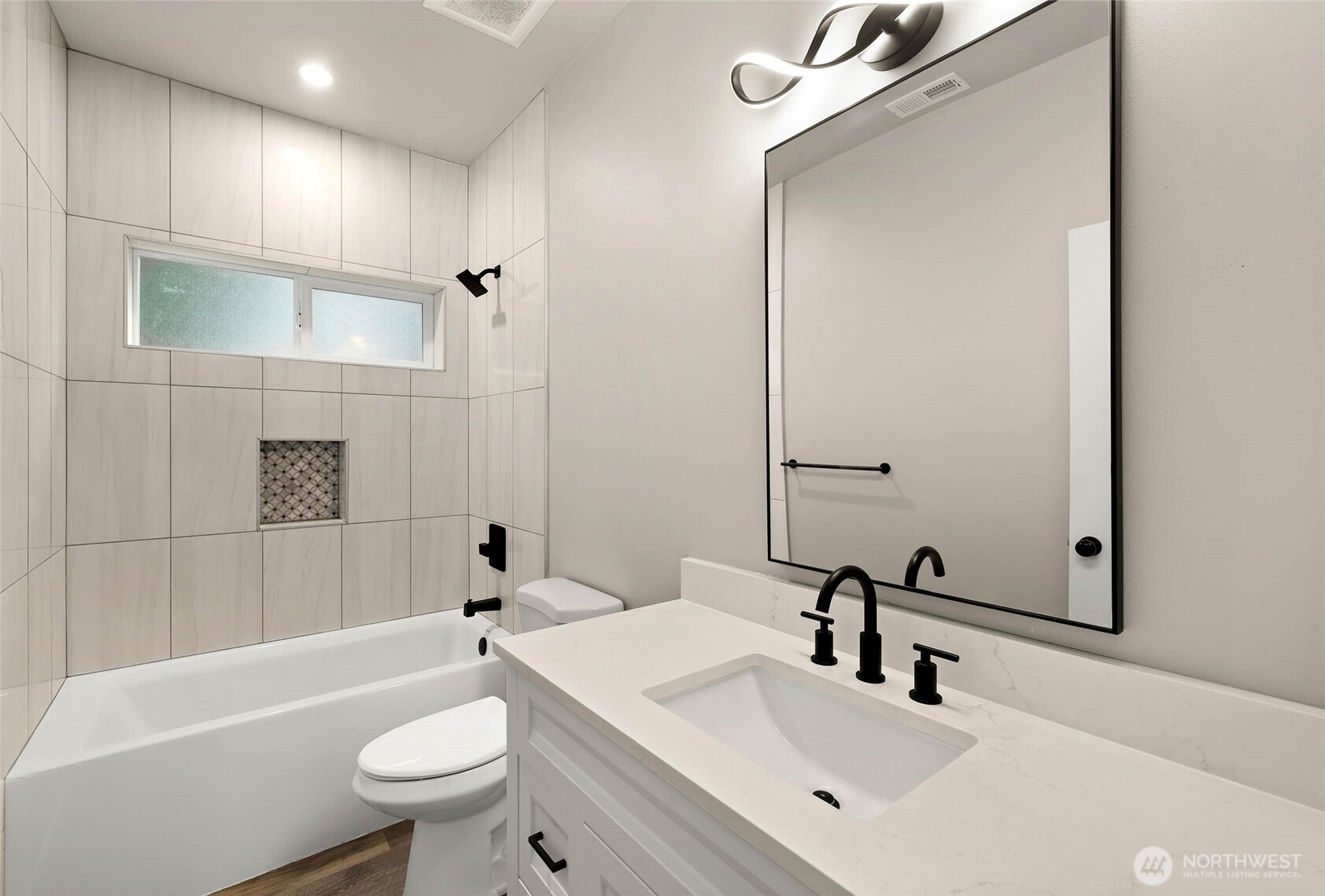 3626 East Howe Street Tacoma, WA 98404 - Photo 13 of 28 a bathroom with a sink a toilet a mirror and bathtub